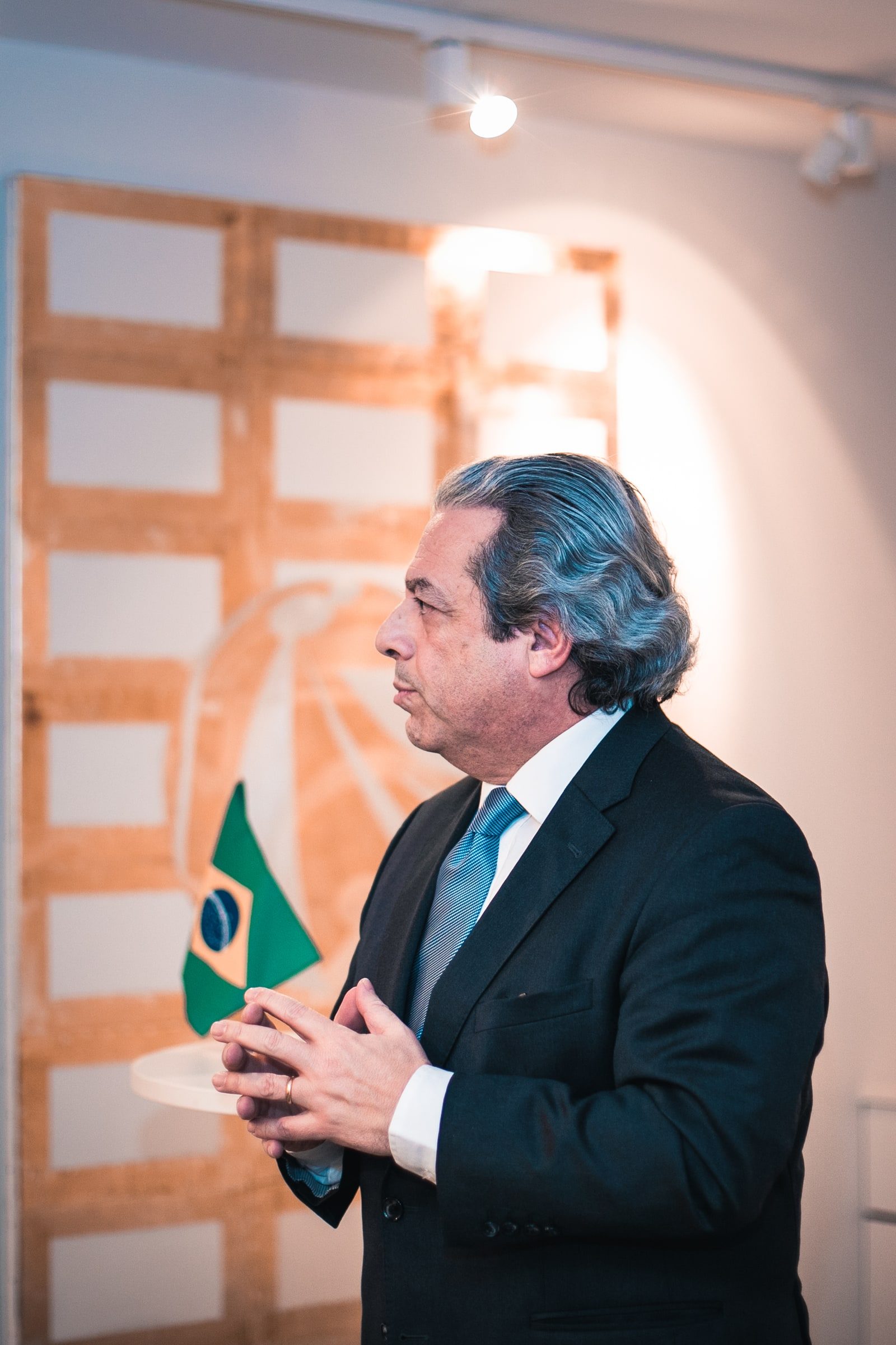 Close profile of a speaker during his address to the reception audience.
