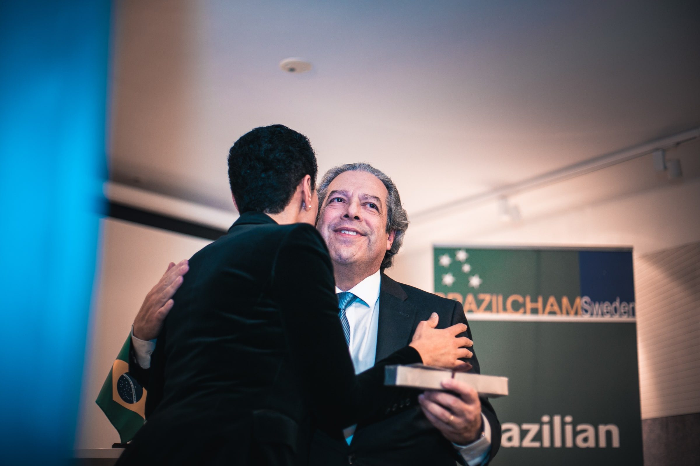 Warm embrace following a formal exchange at the welcome reception.