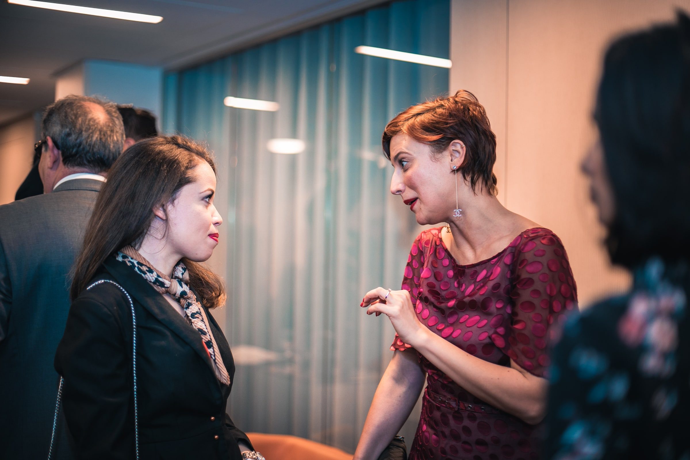 Two women talking during the networking portion of the reception.
