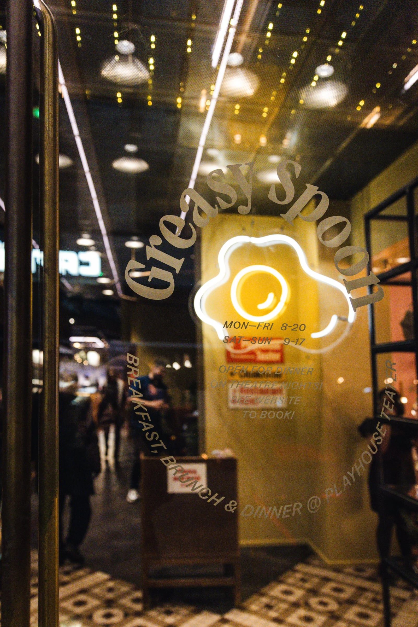 Greasy Spoon entrance and neon sign on restaurant opening night
