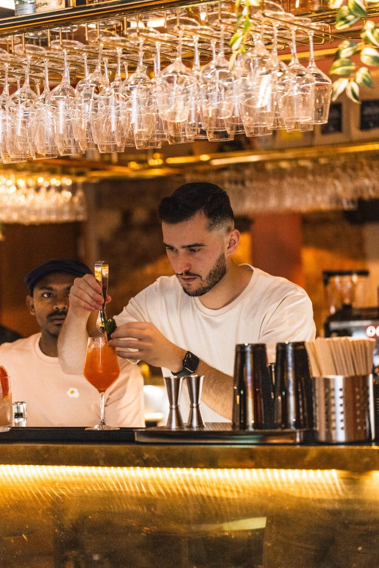 Bartender mixing an orange cocktail at the Greasy Spoon opening