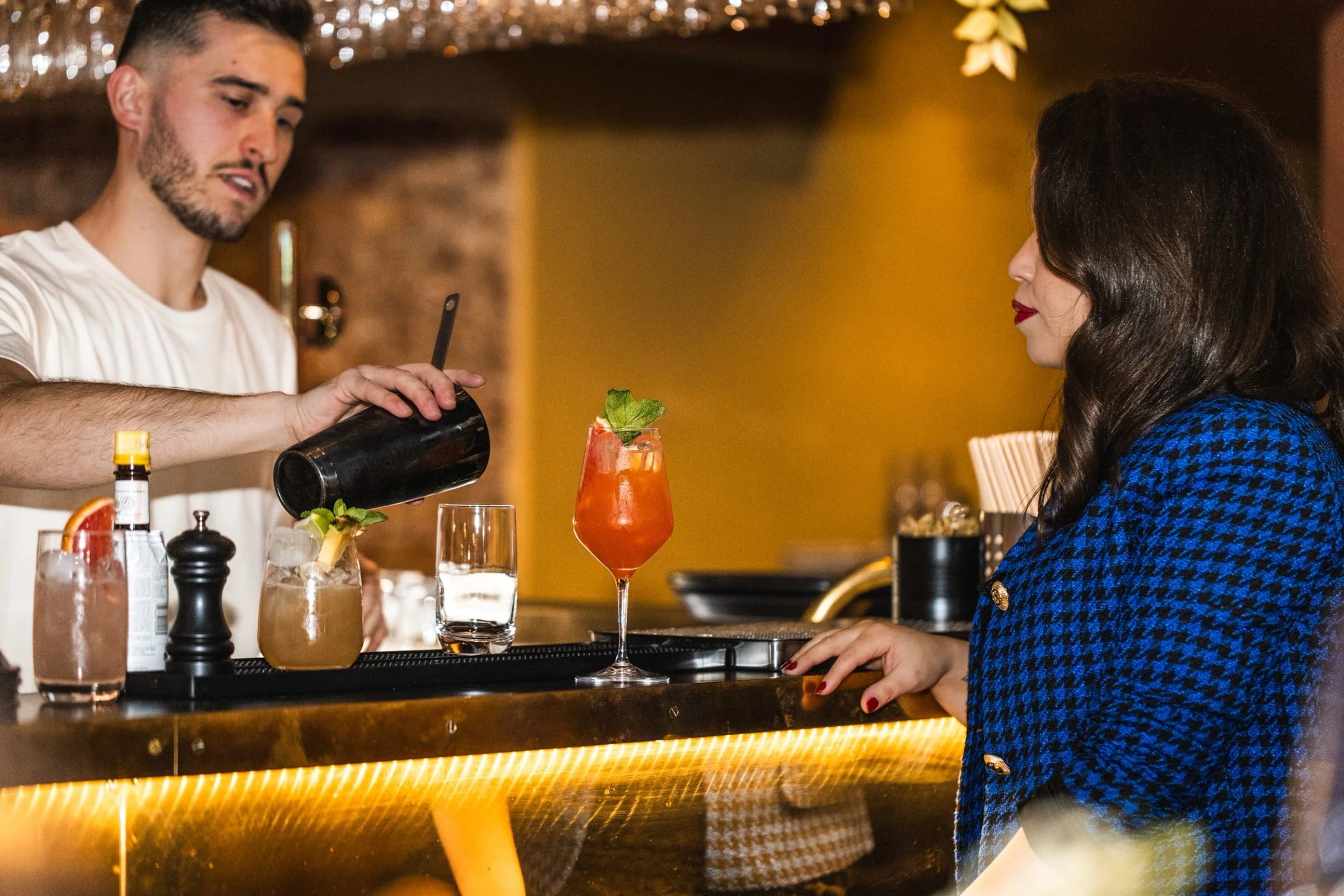 Bartender serving a guest across the Greasy Spoon bar