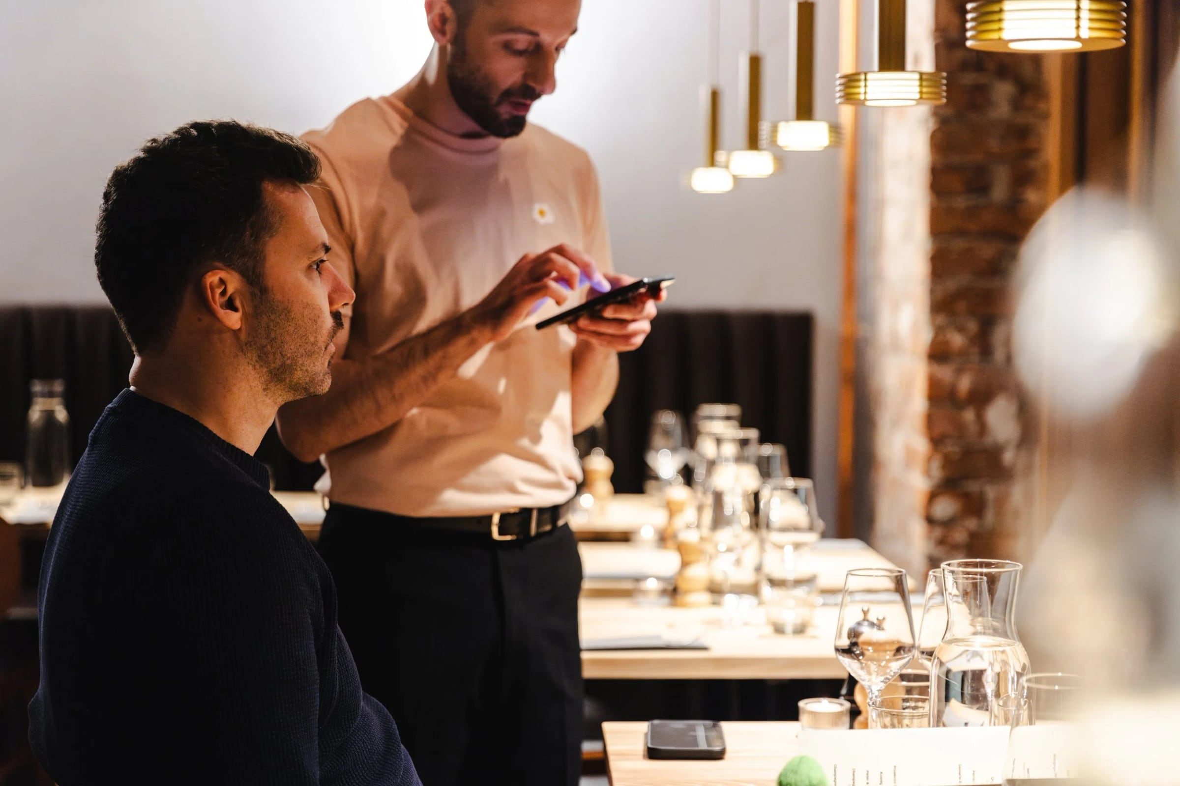 Guests talking at the counter during the restaurant soft opening