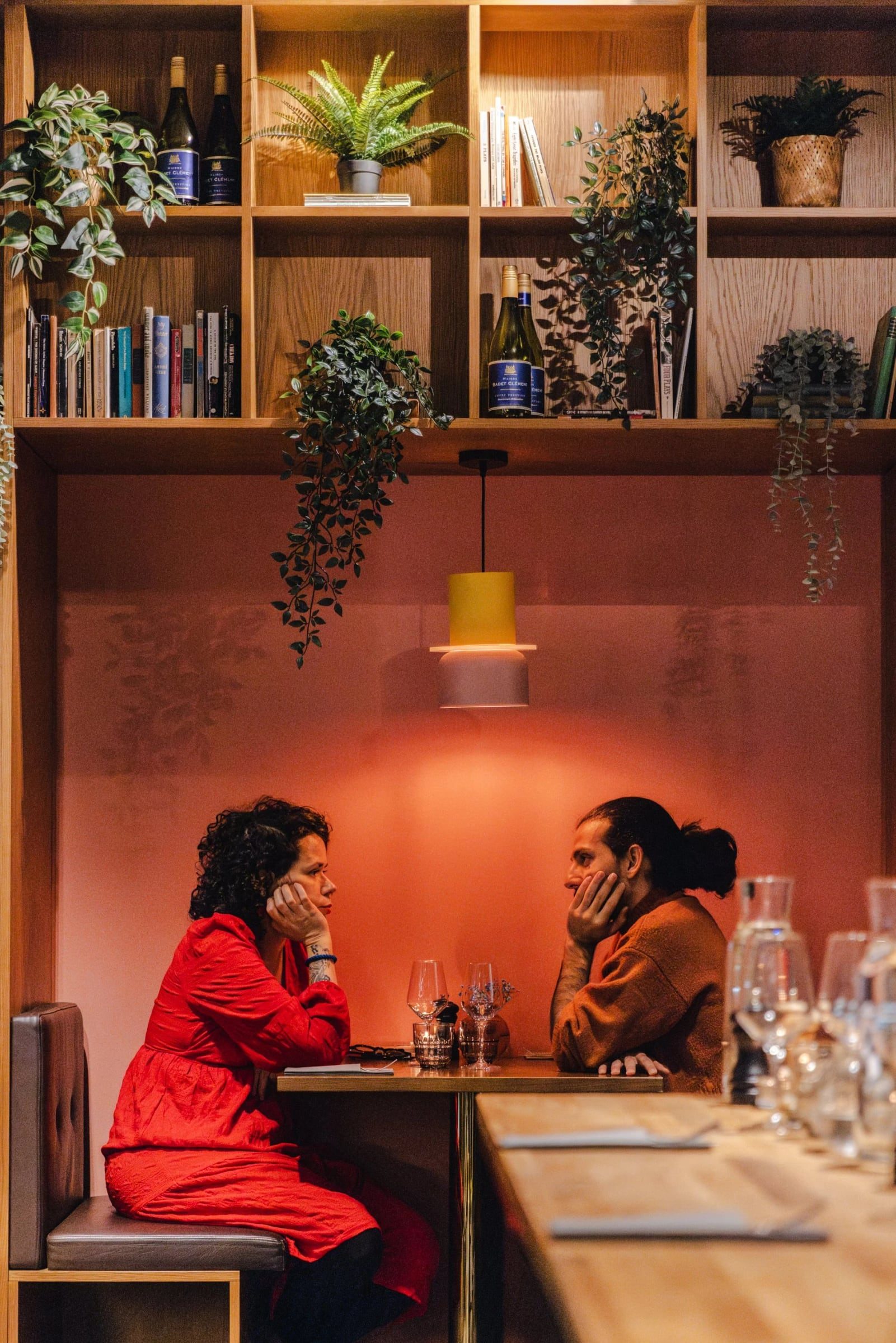 Two guests laughing together in the Greasy Spoon dining room