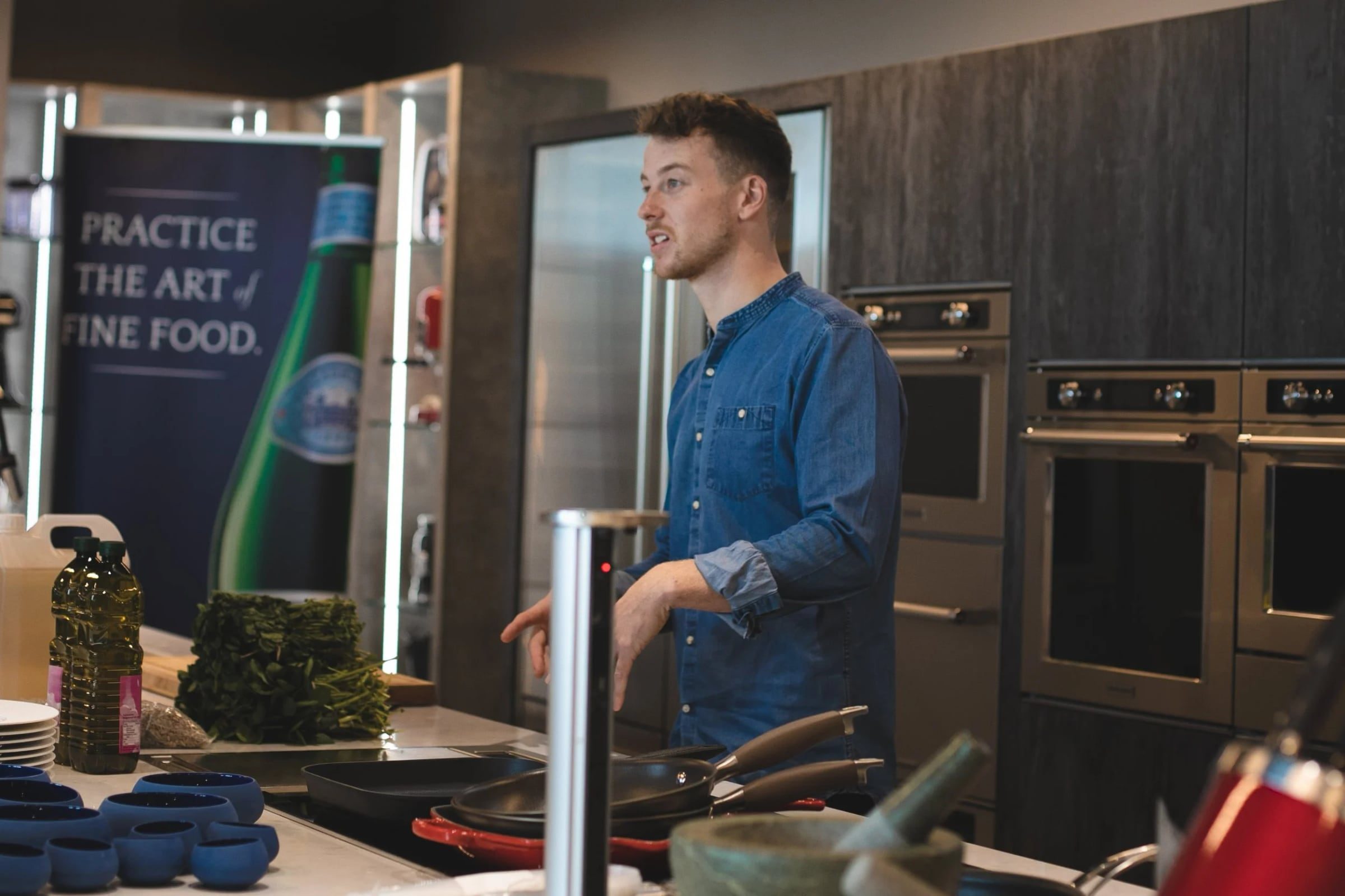 Presenter speaking at a KitchenAid corporate cooking workshop