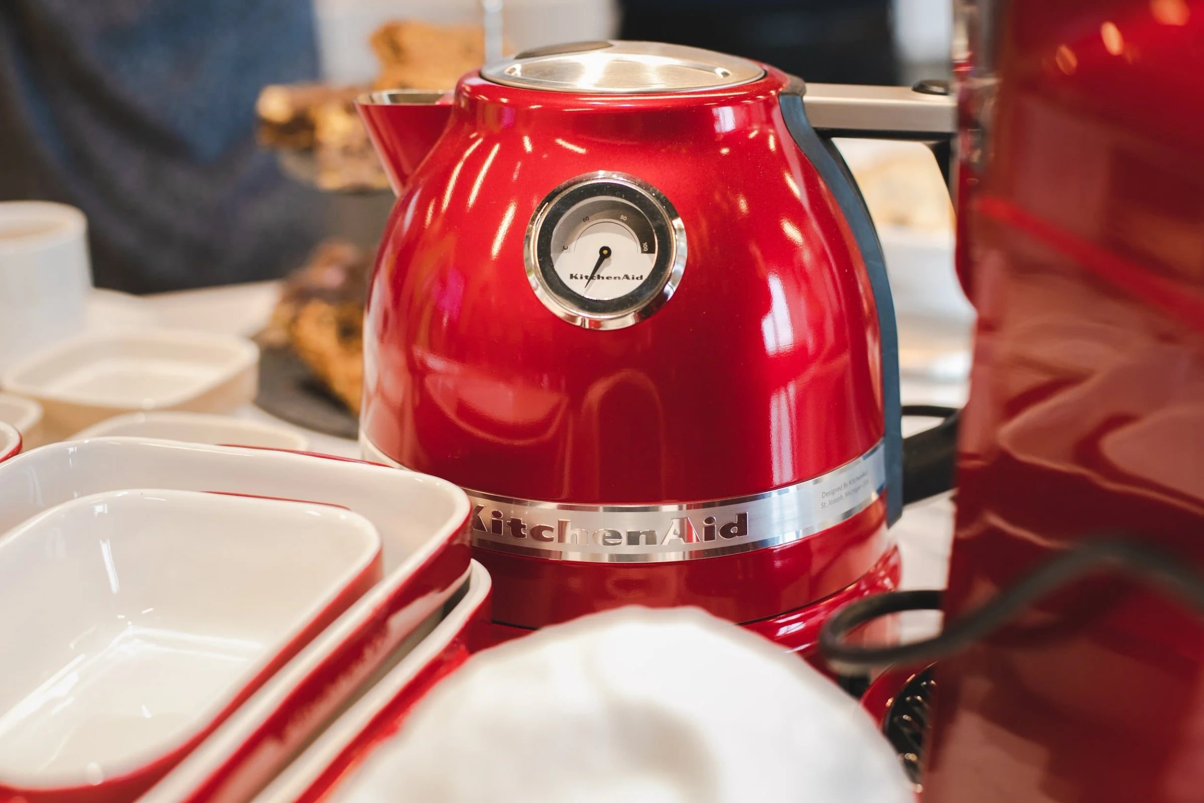 Red KitchenAid kettle among the corporate workshop table settings