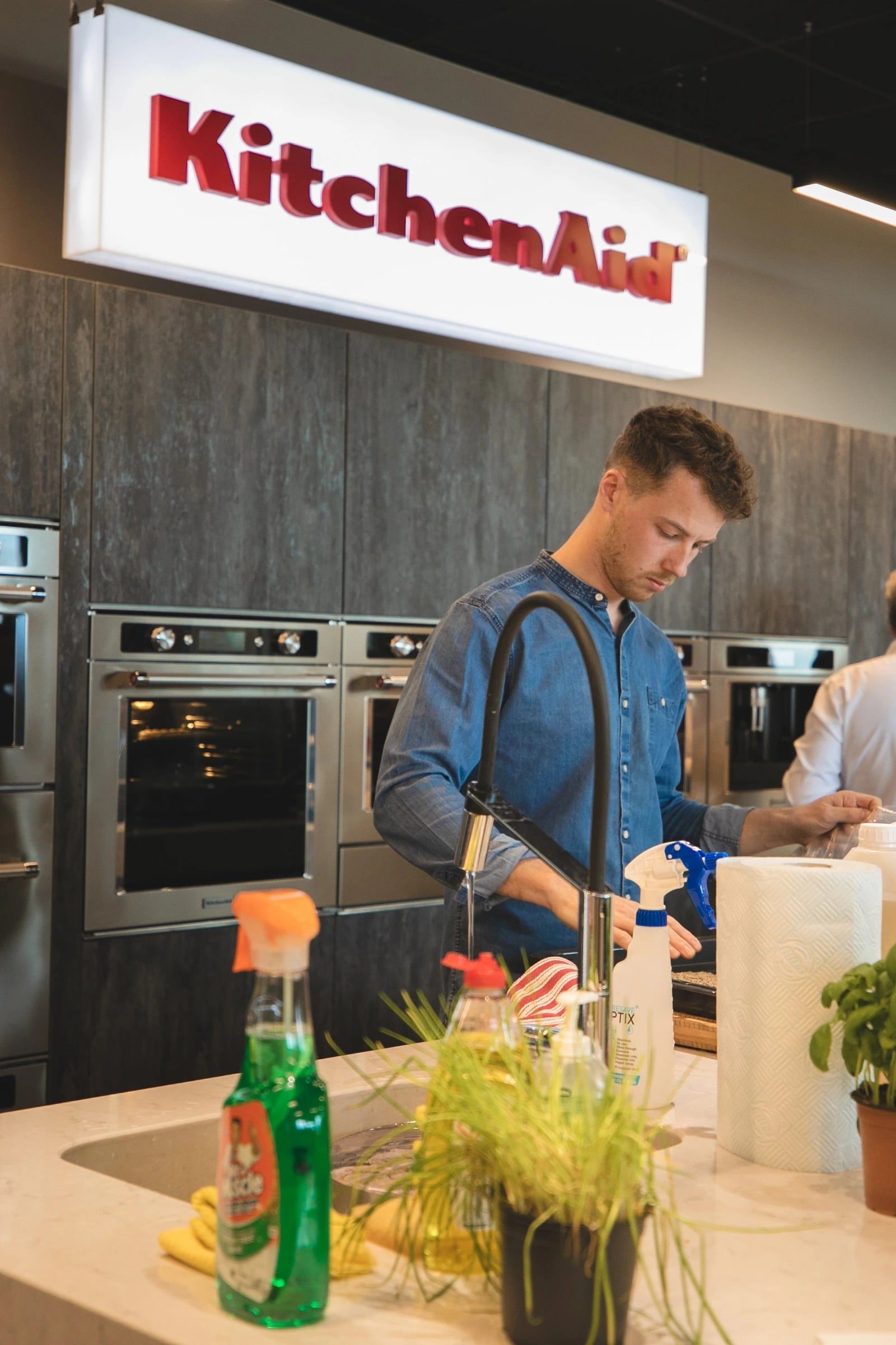Workshop participant preparing ingredients at a demonstration counter