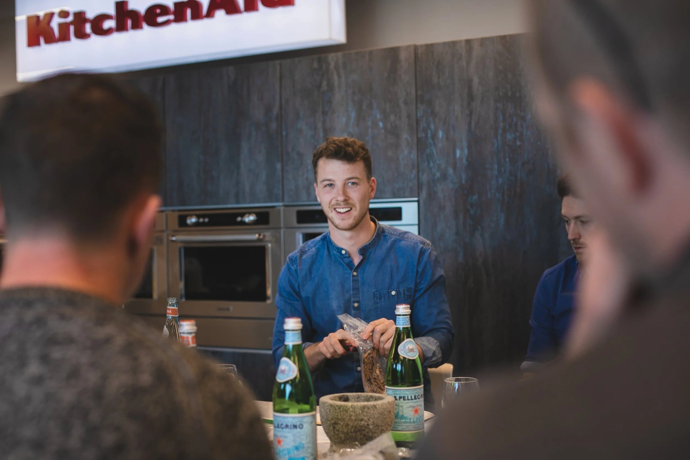 Cooking presenter smiling while speaking to workshop participants