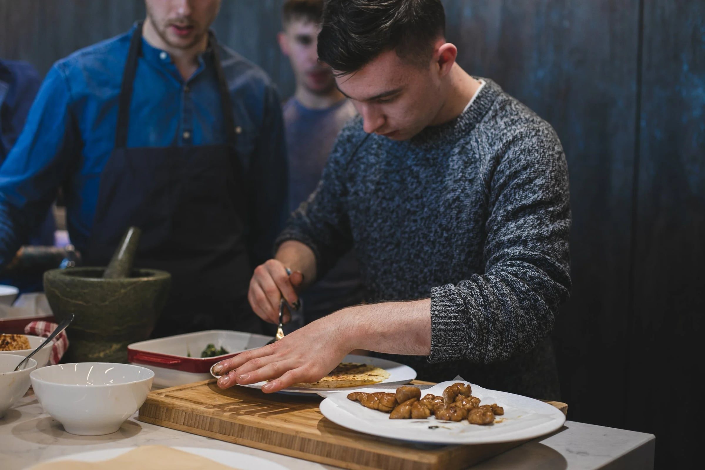 Two participants carefully plating the finished workshop recipe