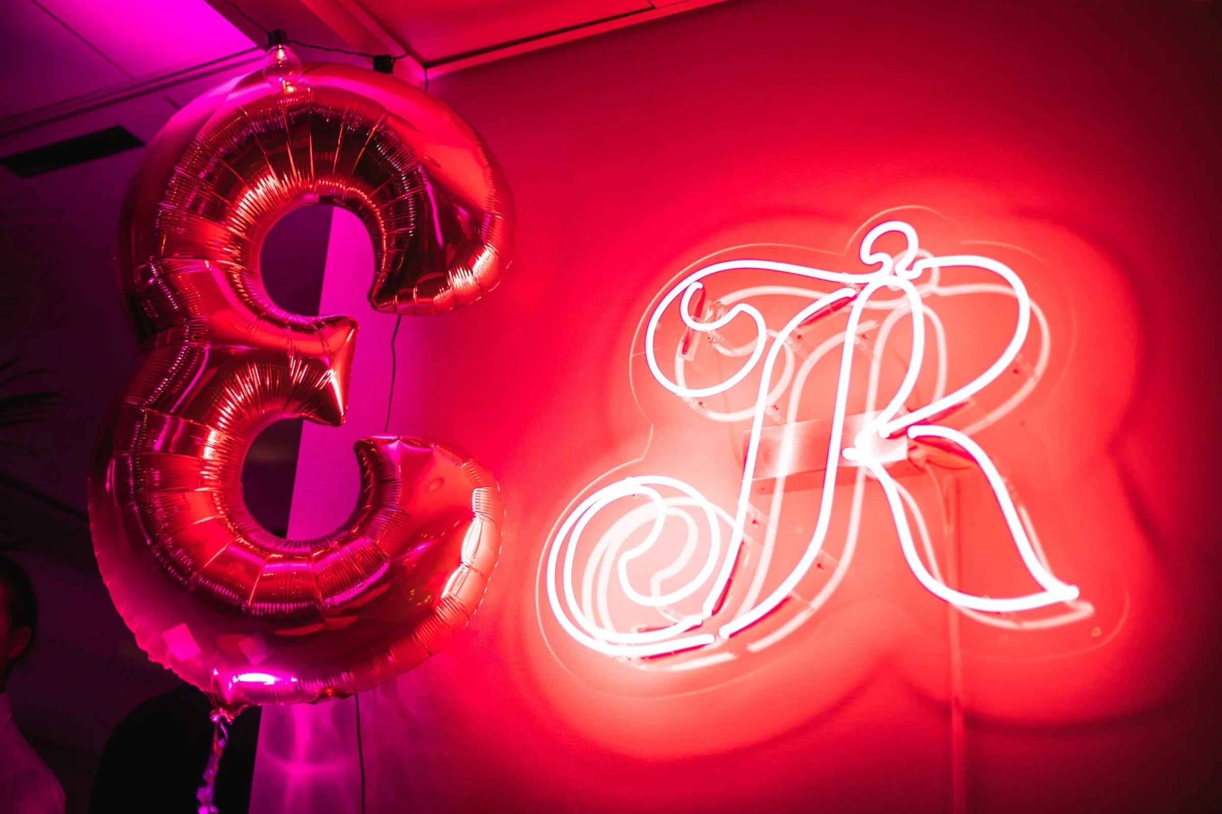 Neon letter and gold balloons decorating Relatable’s anniversary event