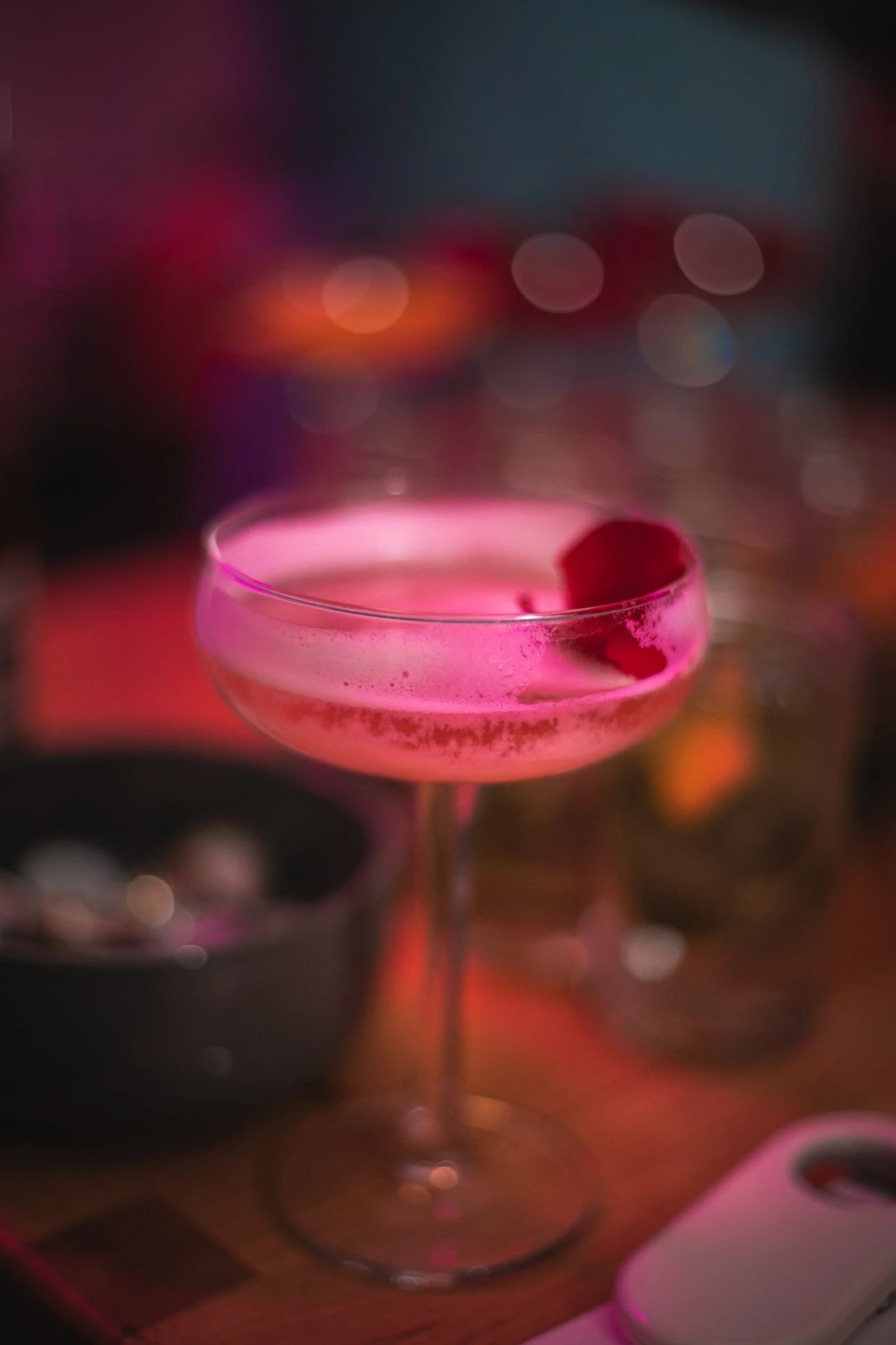 Pink cocktail garnished with a flower at Relatable’s anniversary celebration