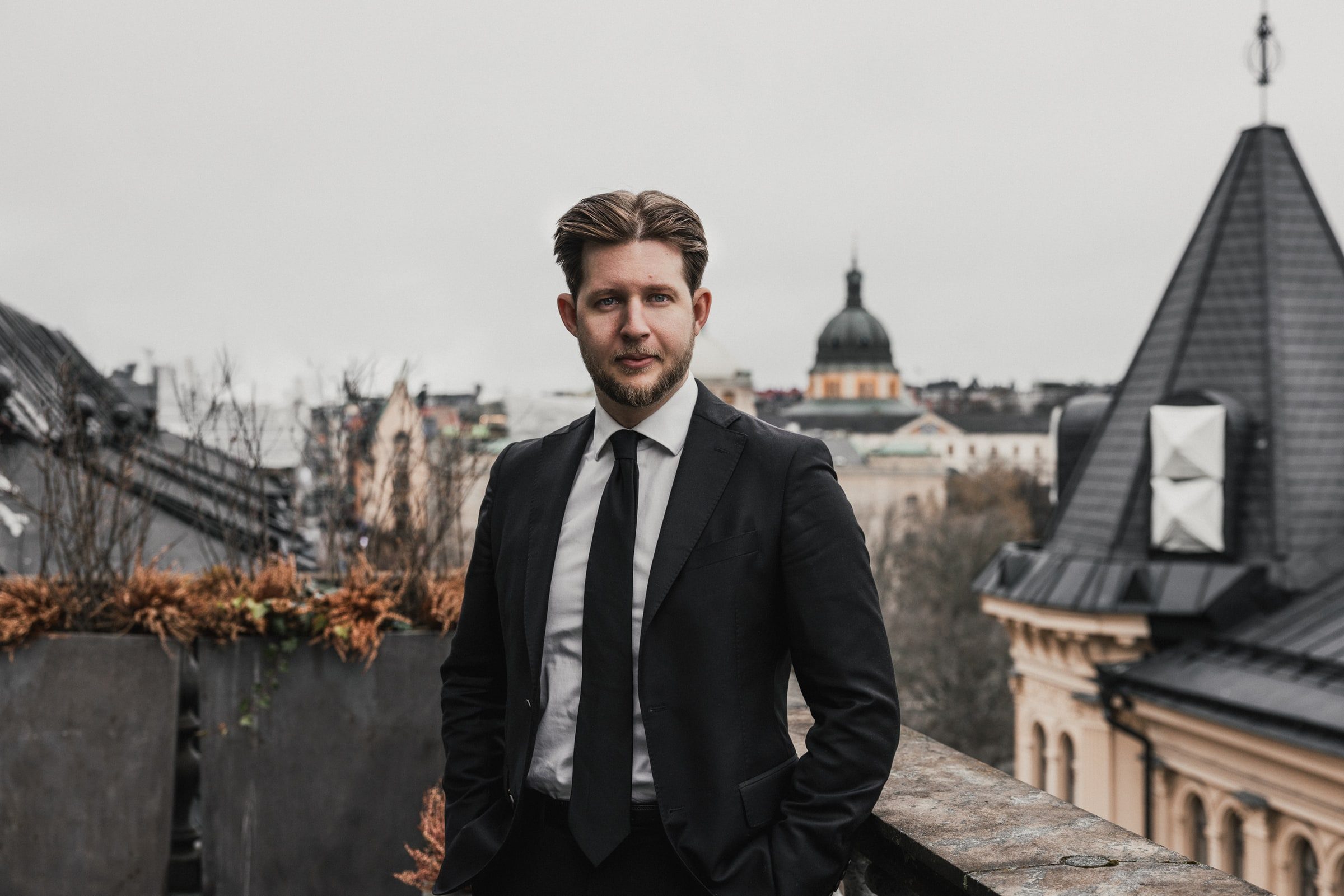 Executive portrait of a concierge on a city rooftop.