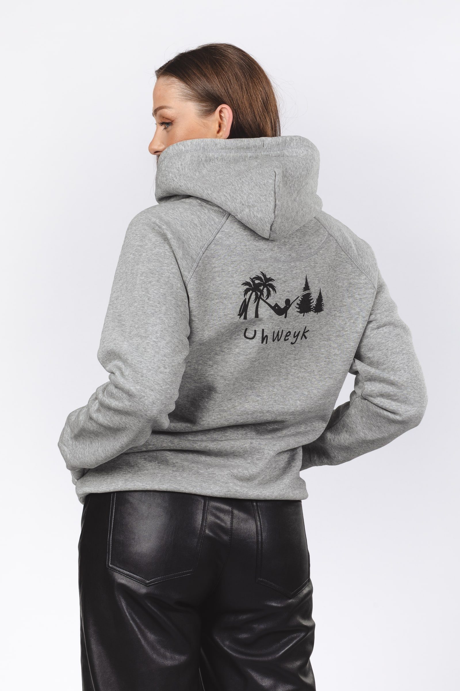 Back of a grey hoodie showing the illustrated brand artwork.
