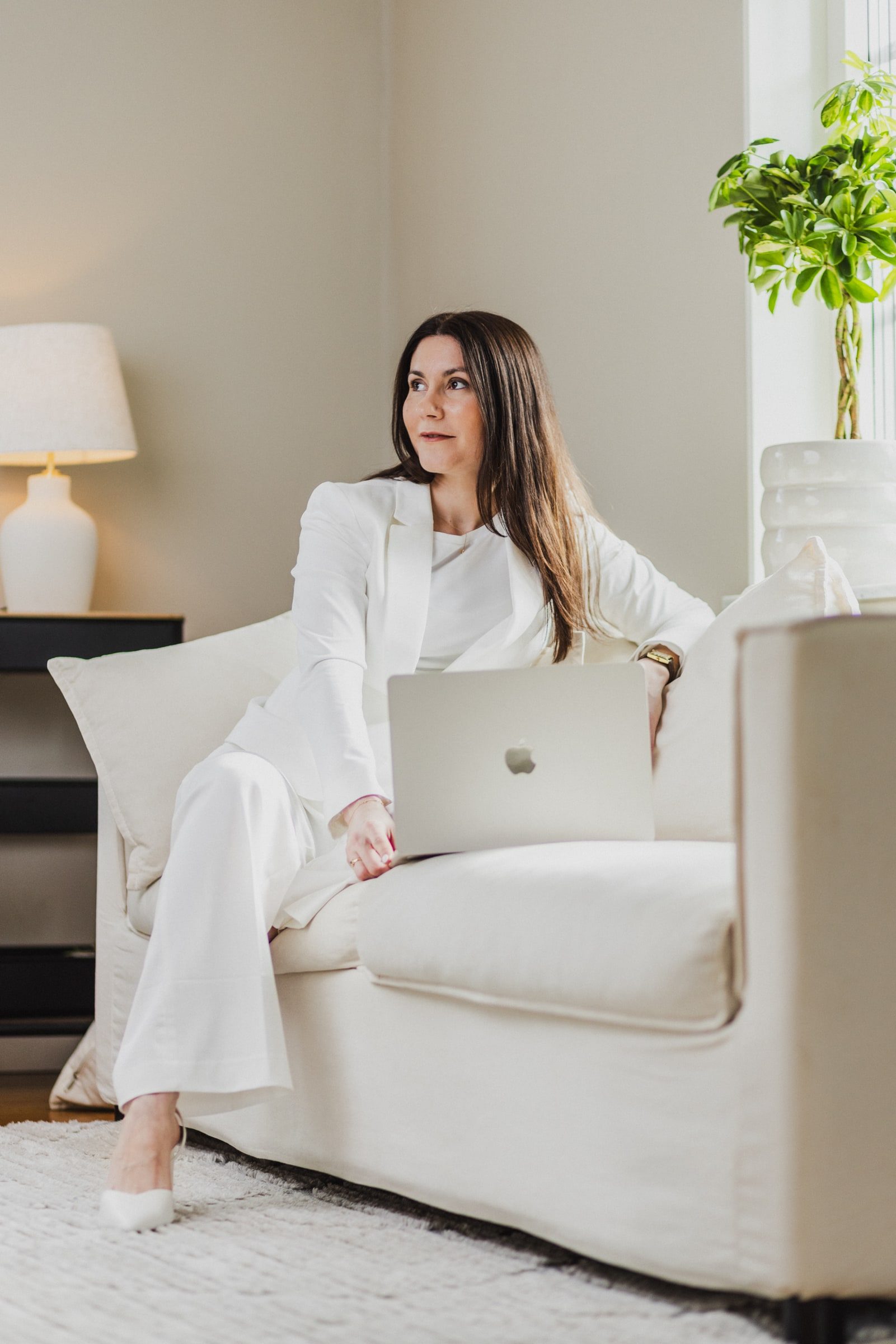 Business coach seated with a laptop during a personal branding session.