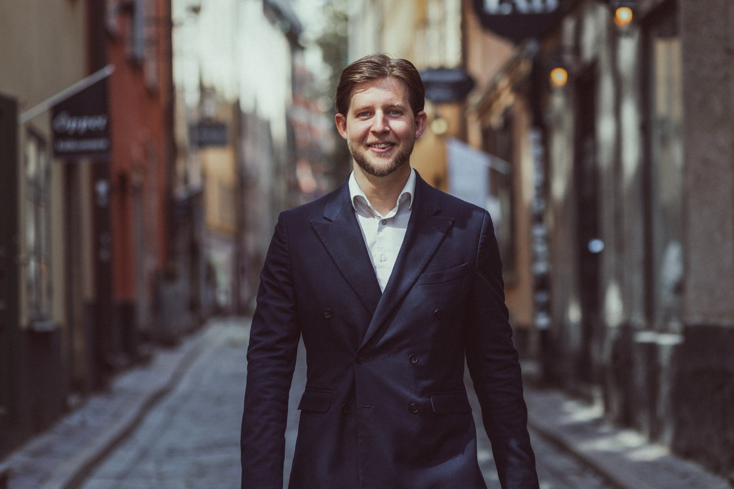 Professional portrait of a concierge standing on a city street.