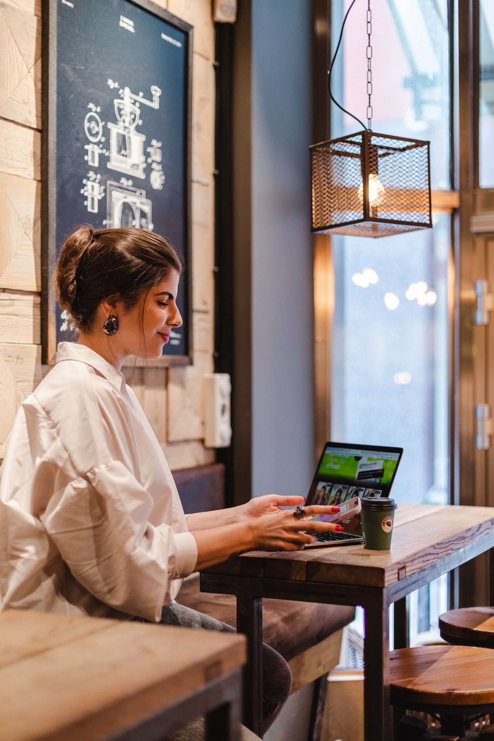 Business coach and writer working beneath illustrated coffee diagrams.