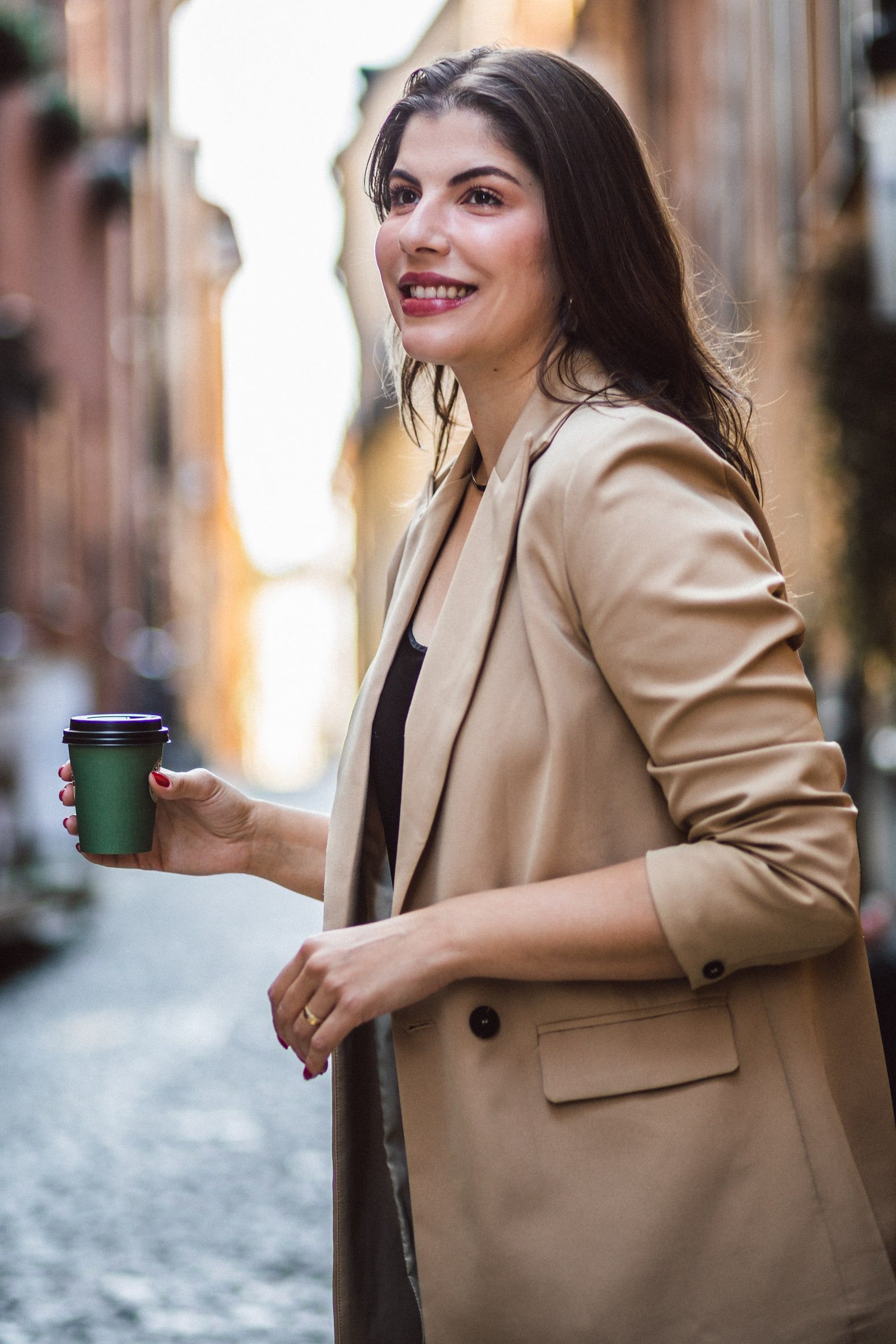 Close editorial portrait of a business coach and writer outdoors.