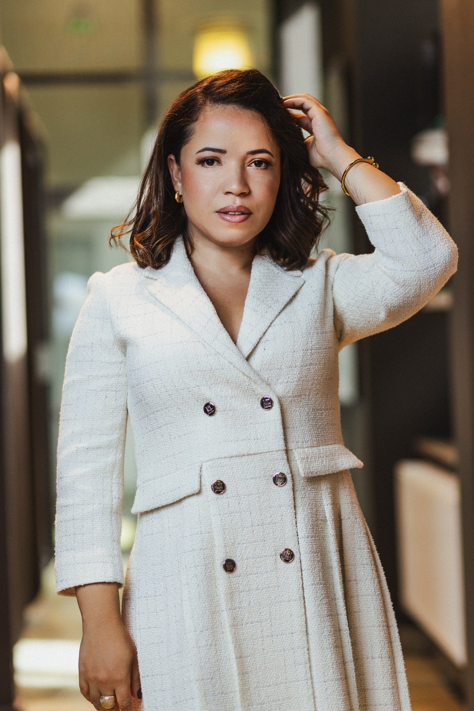 Professional branding portrait with a relaxed editorial pose.