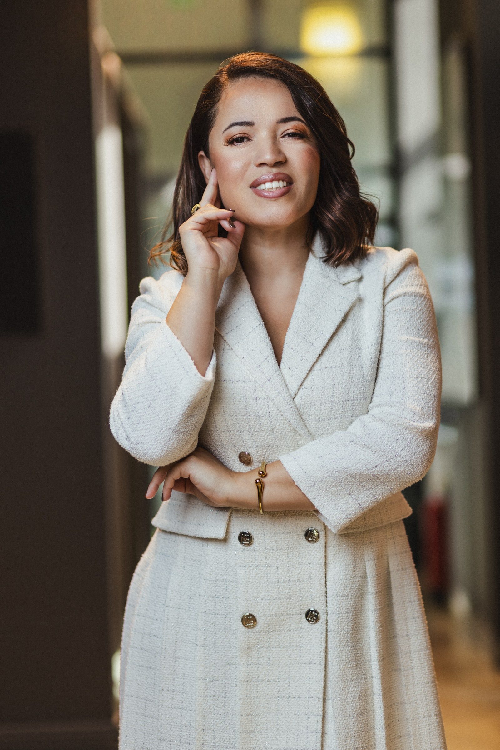 Editorial professional portrait of a woman gesturing naturally.